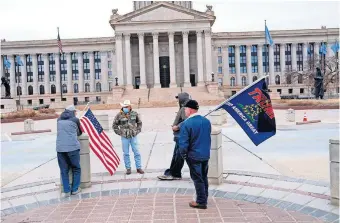  ??  ?? A small group of Trump supporters gathered at the Oklahoma Capitol during the inaugurati­on of Joe Biden on Wednesday. [DOUG HOKE/ THE OKLAHOMAN]