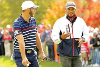  ?? ROB SCHUMACHER, USA TODAY SPORTS ?? United States vice-captain Tiger Woods, right, talks with Dustin Johnson during a practice round for the 41st Ryder Cup tournament at Hazeltine National Golf Club on Thursday.