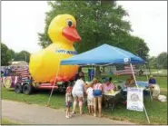  ?? EVAN BRANDT — DIGITAL FIRST MEDIA ?? A Pottstown Fourth of July classic, some people wait until the last minute to buy their tickets to the Rotary Club Duck Race, held in Manatawny Creek. This year, 185 people bought duck tickets in the park.