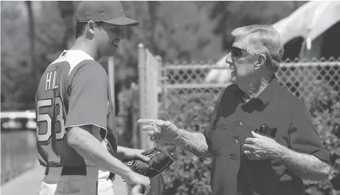  ?? CHIP LITHERLAND / THE NEW YORK TIMES ?? Rich Hill, left, speaks to former Red Sox manager Joe Morgan at spring training in 2011. Hill, a 36-year-old journeyman, bounced between the majors and the minors before a breakout season in 2016 that helped earn him a three-year, $48-million deal with...