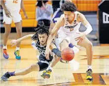  ?? OKLAHOMAN] ?? Pictured left: Oklahoma State's Cade Cunningham (2) and Kansas State's Mike McGuirl (0) fight for a loose ball during the Cowboys' 67-60 win Saturday in Stillwater. [SARAH PHIPPS/ THE