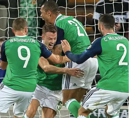  ?? GETTY IMAGES ?? Evans above: Jonny (third left) is the toast of Northern Ireland after scoring against the Czech Republic