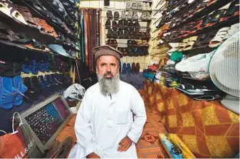  ?? Ahmed Kutty/Gulf News ?? Azad Bahadur Khan in his shop on Electra Street in Abu Dhabi. He pays an annual rent of Dh35,000 for his tiny shop, but the customers he gets makes it worth his while.