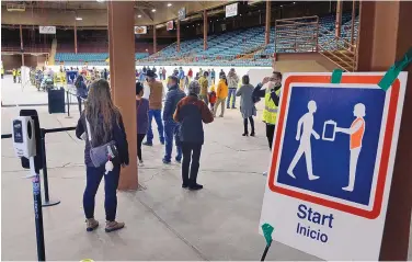  ?? JIM THOMPSON/JOURNAL ?? People enter Tingley Coliseum, a Department of Health vaccinatio­n site, on Jan. 6. Health care workers estimated they averaged just under 300 shots an hour for the 945 people scheduled to receive shots that day.