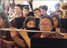  ?? PHOTO ANDY VELEZ ?? Sophomore Andrea Ni (playing flute) and the Calexico High Mighty Bulldog band perform the Star-Spangled Banner early Friday morning for the Binational Health Week event at Lady de Guadalupe Church, in Calexico.