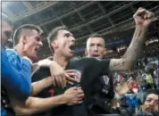  ?? FRANK AUGSTEIN — THE ASSOCIATED PRESS ?? Croatia’s Mario Mandzukic, center, celebrates after scoring his side’s second goal in the semifinal matchup against England Wednesday in Moscow.