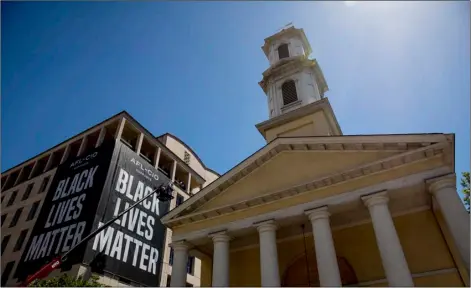  ?? AP Photo/Andrew Harnik ?? This Friday, June 12 file photo shows St. John’s Episcopal Church next to a large “Black Lives Matter” banner on the AFL-CIO building near the White House in Washington.