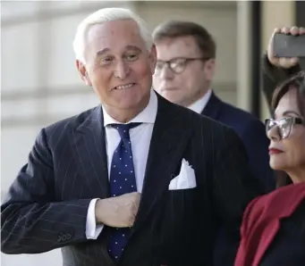  ?? AP PHOTOS ?? NONPLUSSED: Roger Stone, above and right, exits U.S. District Court in Washington, D.C., on Friday. Stone, a longtime friend of President Trump, was found guilty on charges related to alleged Trump campaign coordinati­on with Russia to the 2016 election.