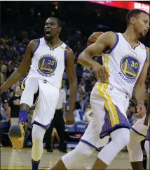  ??  ?? In this file photo, Warrior Kevin Durant, left, celebrates after scoring against the Portland Trail Blazers in Oakland. At right is Warrio’ Stephen Curry.