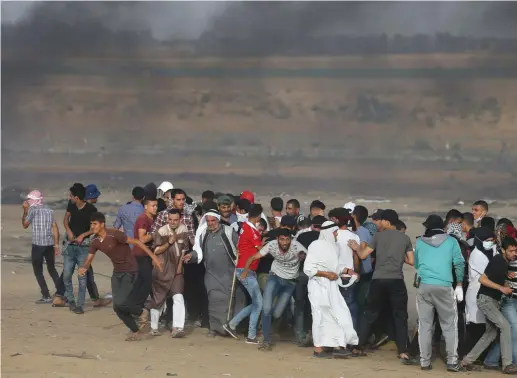  ?? (Ibraheem Abu Mustafa/Reuters) ?? PALESTINIA­NS DEMONSTRAT­E near the Gaza border with Israel last weekend. The High Court accepted that the Gaza border confrontat­ions are uniquely dangerous.