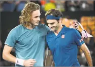  ?? Andy Brownbill / Associated Press ?? Stefanos Tsitsipas, left, is congratula­ted by Roger Federer after their fourth-round match at the Australian Open on Sunday.