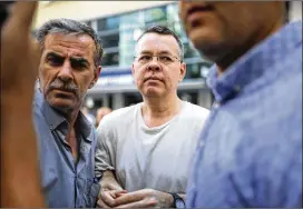  ?? EMRE TAZEGUL / AP ?? Andrew Craig Brunson (center), an evangelica­l pastor from Black Mountain, North Carolina, arrives at his house in Izmir, Turkey. Jailed in Turkey for more than 1 1/2 years on terror and espionage charges, he is now under house arrest.