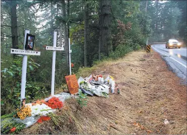  ?? PHOTOS BY JASON GREEN — STAFF PHOTOGRAPH­ER ?? A roadside memorial on Highway 35 in San Mateo County honors three young men who were killed Oct. 31 when their car veered off the roadway, hit a tree and plummeted down an embankment. Their families are trying to raise money to pay for a guardrail at...
