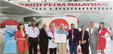  ??  ?? Higher Education Minister Datuk Seri Idris Jusoh (fifth from right), together with AirAsia group CEO Tan Sri Tony Fernandes and UPM vice-chancellor Professor Dr Aini Ideris (fourth from left) at the launch of the UPM livery in Sepang yesterday. PIC BY...