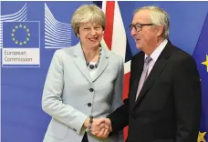  ?? AFP ?? Theresa May with EC president Jean-Claude Juncker