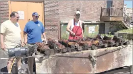  ?? Photo by Becky Polaski ?? From left, St. Marys Rotary Club members Bob Roberts, John Gorlowski, and Fran Levenduski are shown checking on the first batch of beef for the club’s annual sale as it finishes cooking on Thursday morning.