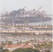  ?? DAMIAN DOVARGANES/AP ?? Container cargo ships are docked this month in the Port of Los Angeles. Ships holding up to 14,000 containers have sat offshore, some for over a week.