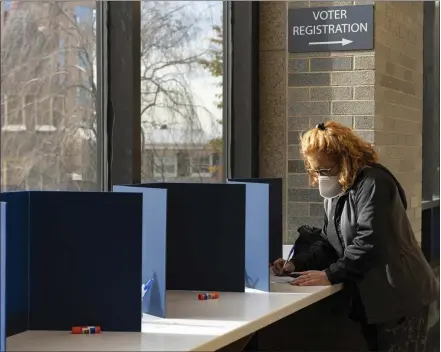  ?? RUTH FREMSON/THE NEW YORK TIMES ?? A voter fills in a ballot at the Board of Elections office in Doylestown in 2022. Pennsylvan­ia will begin using automatic voter registrati­on.