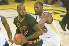  ??  ?? CARY EDMONDSON, USA TODAY SPORTS LeBron James, driving vs. Draymond Green, says the Cavaliers, down 2-0 to the Thunder in the Finals, don’t plan to slow down.