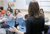  ?? LUIS SÁNCHEZ SATURNO/THE NEW MEXICAN ?? Angel Martínez, 17, left, and Natasha Montaño, 17, listen as Jocelyn Jansons, director and founder of New Mexico Girls Make Movies, speaks at Capital High School on Wednesday as part of a Communitie­s In Schools presentati­on.