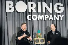  ??  ?? Elon Musk, co-founder and CEO of Tesla, left, speaks as Steve Davis, operations head of The Boring Company, listens during a Boring event in Los Angeles in May.