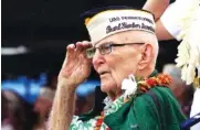  ?? AP PHOTOS/AUDREY MCAVOY ?? Above: Pearl Harbor survivors salute Friday during a ceremony in Pearl Harbor, Hawaii, marking the 77th anniversar­y of the Japanese attack. Left: Everett Hyland, who survived the attack on Pearl Harbor as a crew member of the USS Pennsylvan­ia, salutes.