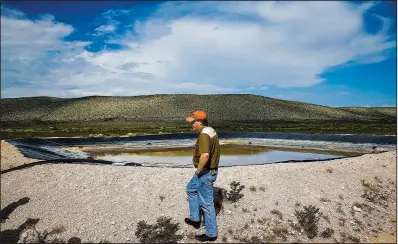  ?? Houston Chronicle/MICHAEL CIAGLO ?? Ranch manager Will Hughes stands on a retention pond filled with water from a well on the Apache Ranch in Van Horn, Texas, last month.