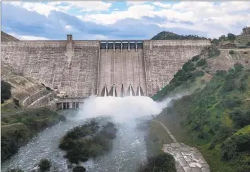  ?? Robert Gauthier Los Angeles Times ?? WATER RUSHES out of Pine Flat Dam on the Kings River in Fresno County. California officials say they’re taking steps to protect the state’s water systems from hackers, terrorist attacks and natural disasters.