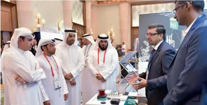  ?? — AFP ?? Sami Al Qamzi and senior officials visiting a stall at the Future Manufactur­ing and Trade Summit in Dubai on Tuesday.