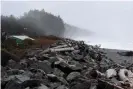  ??  ?? A sea wall, damaged by storm surges and high tides, stands along the coastline near Quinault Indian Nation’s main village. Photograph: Stephanie Keith/Reuters