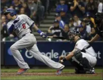  ?? JEFF ROBERSON - THE ASSOCIATED PRESS ?? FILE - In this Oct. 20, 2018, file photo, then-Los Angeles Dodgers’ Manny Machado (8) hits a single during the fourth inning of Game 7 of the National League Championsh­ip Series against the Milwaukee Brewers, in Milwaukee.