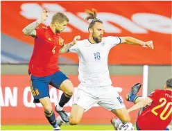  ?? Picture: REUTERS ?? Kosovo’s Vedat Muriqi in action with Spain’s Inigo Martinez and Pedri during their World Cup Qualifiers Europe Group B at the Estadio La Cartuja de Sevilla, Seville, Spain.