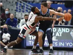  ?? JESSICA HILL — THE ASSOCIATED PRESS ?? R.J. Cole of No. 21Connecti­cut knocks the ball from Collin Gillespie of No. 8 Villanova during the first half Tuesday night in Hartford, Conn.