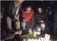  ?? GETTY IMAGES ?? Members of the public light candles during a vigil Thursday for victims of the Westminste­r attack in London.