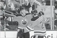  ?? JASON FRANSON THE CANADIAN PRESS ?? Oilers’ Connor McDavid, left, and Leon Draisaitl celebrate a goal against the Tampa Bay Lightning in second-period action in Edmonton on Monday night. McDavid scored four times and added an assist in a 6-2 Oilers victory.