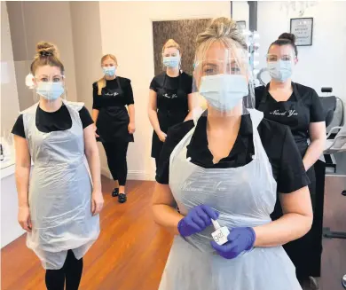  ??  ?? Kitted out Marie and her team have taken all precaution­s to make sure they and the salon are safe for treatments