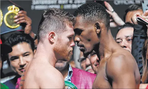  ?? Erik Verduzco Las Vegas Review-journal @Erik_verduzco ?? Saul “Canelo” Alvarez and Daniel Jacobs face off during their weigh-in Friday at T-mobile Arena for their middleweig­ht title bout Saturday.