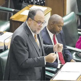  ?? (Photo: Garfield Robinson) ?? Opposition Leader Mark Golding makes his presentati­on in the 2023/24 Budget Debate in Parliament, Tuesday. Beside him is Julian Robinson, the spokesman on finance.