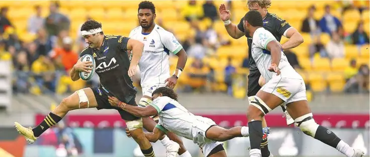  ?? Photo: Stuff ?? Hurricanes No.8 Tyler Laubscher (with ball) tries to break away from Simione Kuruvoli’s tackle as Isoa Nasilasila and Meli Derenalagi close in at the Sky Stadium, Wellington on May 8, 2022.