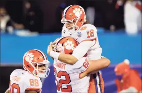  ?? Jared C. Tilton / Getty Images ?? Clemson quarterbac­k Trevor Lawrence (16) celebrates with teammates after scoring a 34-yard rushing touchdown against Notre Dame on Saturday.