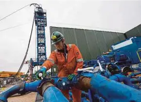  ?? REUTRES PIC ?? A engineer opening a valve next to the coil tubing tower as shale gas developer Cuadrilla Resources prepare to start fracking for gas at its Preston New Road site near Blackpool this week.