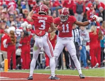  ?? AP PHOTO/VASHA HUNT ?? Alabama wide receivers Jermaine Burton and Traeshon Holden celebrate after Burton’s 4-yard touchdown catch in the second quarter of Saturday’s home win against Austin Peay.