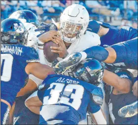  ?? ?? Rebels quarterbac­k Doug Brumfield powers through the Utah State defense for a score in the team’s third win in four games.