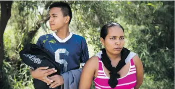  ??  ?? Cecilia Ulloa, 25, and her son Darwin, 13, wait after being detained in Hidalgo County, Texas. Ulloa said she fled Honduras to escape her stepfather, who, after being released from prison for rape, was stalking her and Darwin.