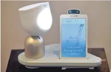  ?? TNS PHOTO ?? HOME COMPANION: ElliQ’s smart speaker moves on its own when communicat­ing with a user and lights up to signal it’s paying attention. The tablet screen displays music and closed captioning responses.