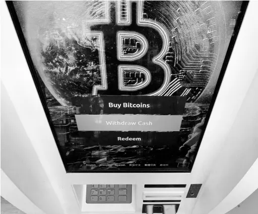  ?? AP ?? The Bitcoin logo appears on the display screen of a cryptocurr­ency ATM at the Smoker’s Choice store, Tuesday, February 9, 2021, in Salem, New Hampshire.