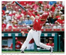  ?? GARY LANDERS / AP ?? The Reds’ Tucker Barnhart hits a two-run home run off Cardinals reliever John Gant during the sixth inning of Wednesday’s 7-3 victory at Great American Ball Park.