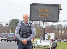  ?? TANYA BREEN/ASBURY PARK PRESS ?? Holmdel Patrolman Matthew Menosky, who started the traffic enforcemen­t program, Goal: Zero, in honor of his friend’s brother who was killed at the age of 16 by a drunk driver in Middletown, stands along Route 35 North in Holmdel on Tuesday4. Fourteen police agencies agred to take part in the traffic enforcemen­t detail along Route 35 from 3 p.m. to 7 p.m. on Wednesday.