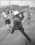  ?? By Wojtek Radwanski, Afp/getty Images ?? Skirmish: Riot police react after Polish and Russian soccer fans clashed Tuesday in Warsaw.