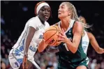  ?? HAN/DETROIT FREE PRESS
JUNFU ?? Michigan State guard Tory Ozment goes to the basket against North Carolina forward Maria Gakdeng during the first half Friday at Colonial Life Arena in Columbia, S.C.